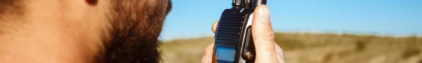2a38106c-278d-4599-b375-129b45cff056-young-handsome-man-talking-walkie-talkie-radio-enjoying-canyon-view.jpg